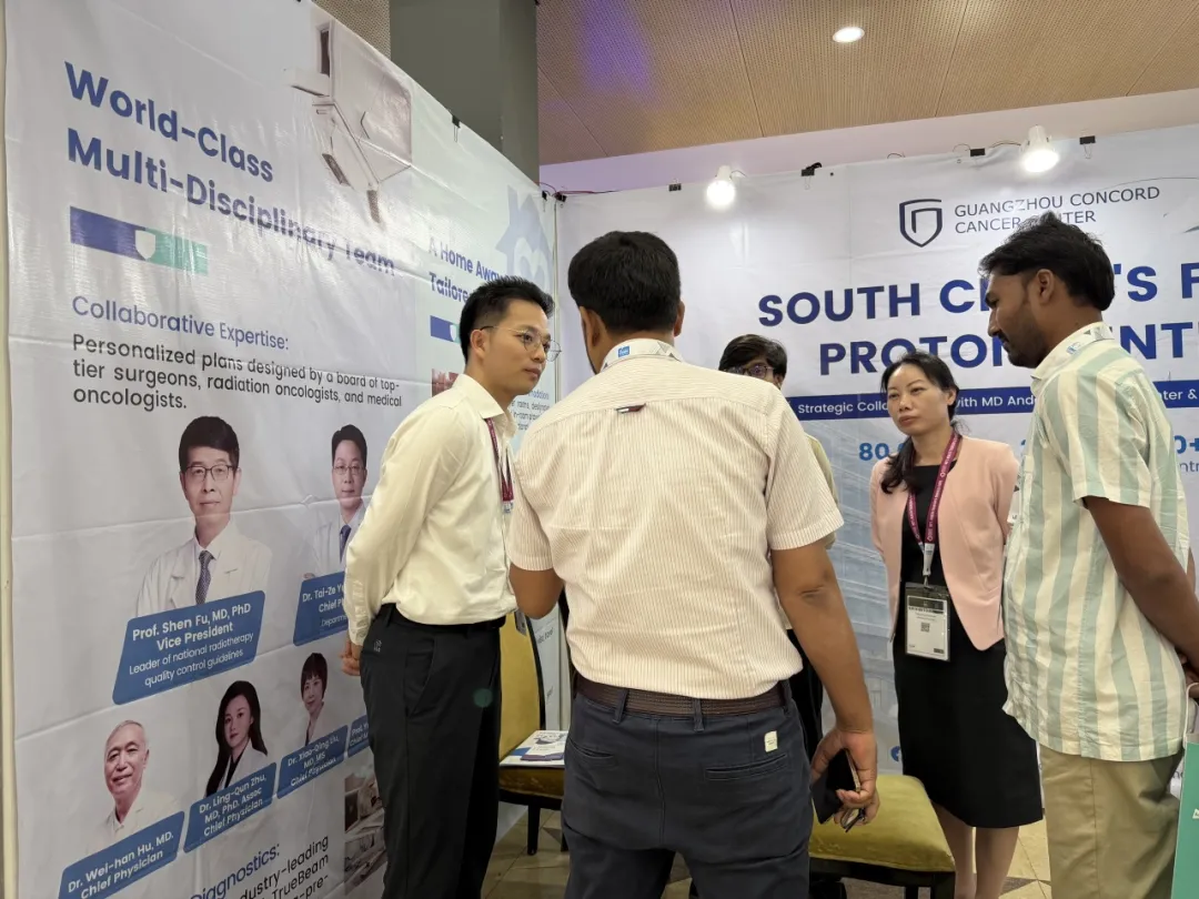 Local doctors consulting with GCCC team about proton therapy indications at the Dhaka exhibition booth